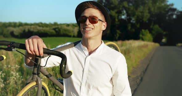 Man Walking with Bicycle on Shoulder