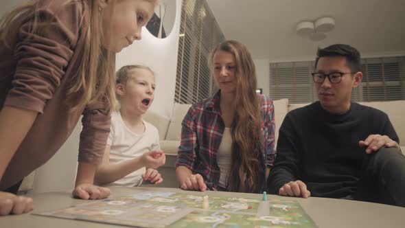 Family Playing A Board Game