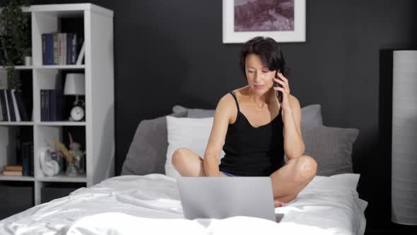 Woman Using Mobile and Laptop