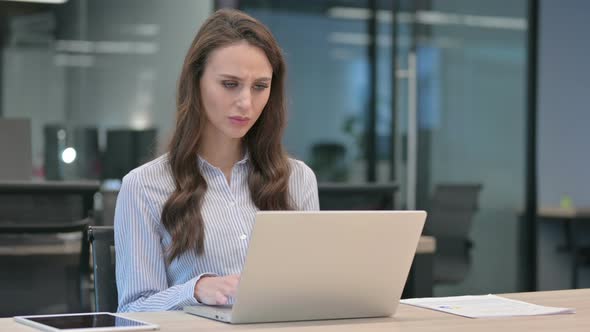 Young Businesswoman Reacting to Loss While using Laptop alt