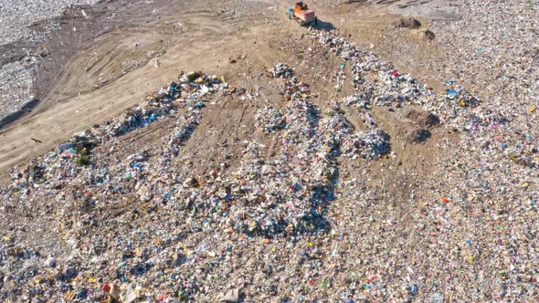 Garbage Trucks Unload Garbage in a City Landfill alt