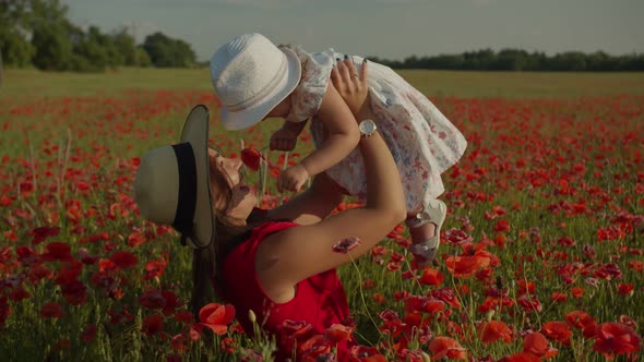 Mom Circles Her Daughter in a Poppy Field