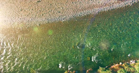 Low Altitude Flight Over Fresh Fast Mountain River with Rocks at Sunny Summer Morning. alt