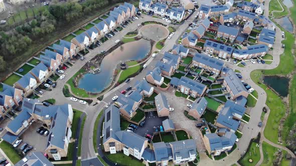 Aerial view of modern houses with an artificial pond in the middle in Greenhithe, Kent alt