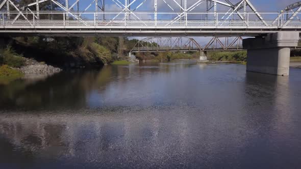 Drone flying underneath new Truss bridge with old bridge in the background on Russian River in Heald alt