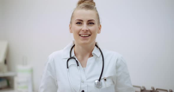 Positive Doctor Puts on Stethoscope and Smile alt