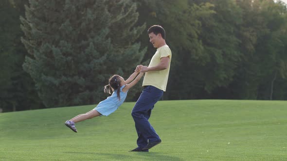Loving Asian Dad Playing with His Lovely Daughter alt