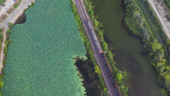 Aerial View of Freight Train with Coal Moving By Rail Among Green Nature alt