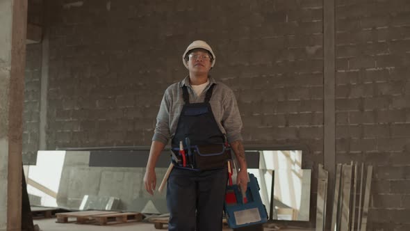 Construction Worker Walking with Toolbox alt