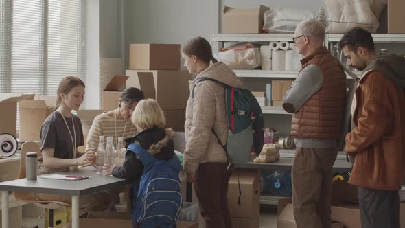 Volunteers Providing Humanitarian Aid to Refugees alt