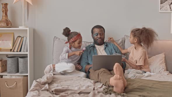 Father of Two Pretty Daughters Working on Laptop from Home alt