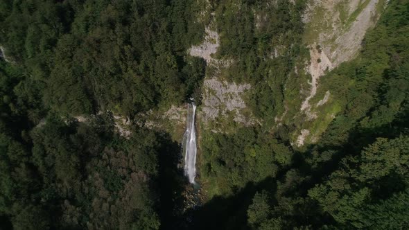 Flying Above the High Epic Waterfall in the Green Woods in Summer, Georgia