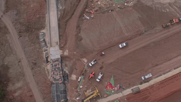 Aerial view flying over construction worksite at lake alt