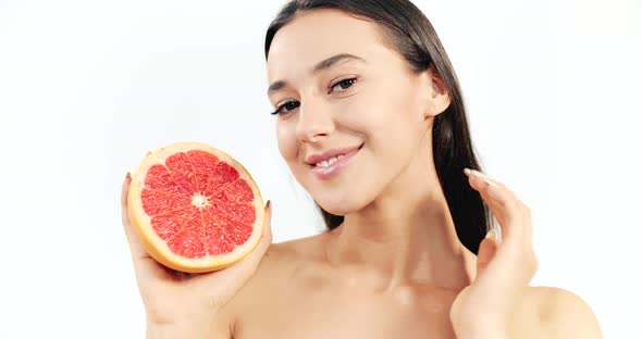 Woman with Grapefruit Isolated on White