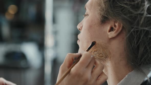 SFX Artist Applying Makeup on Prosthetic Scar alt