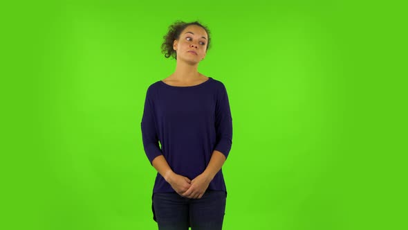 Curly Woman Standing Waiting with Boredom. Green Screen alt