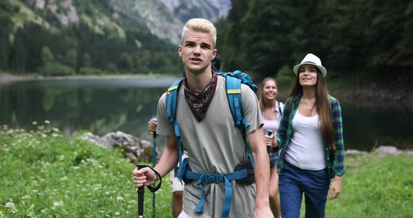 Group of People Hiking in Nature on a Summer Day alt