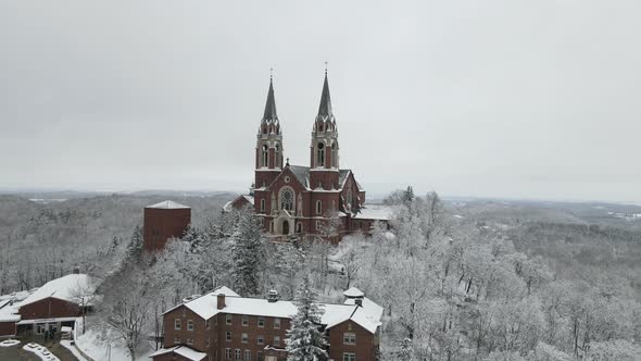 Architecturally detailed religious complex in the forest. Snow covering the ground and trees.