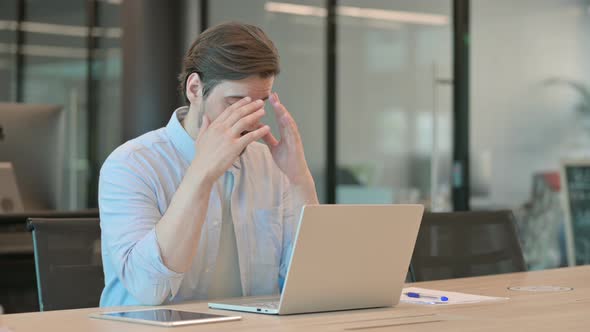 Man with Laptop Having Headache alt