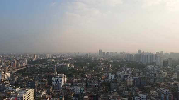 Descending drone shot with views of Dhaka's polluted skyline, Bangladesh alt