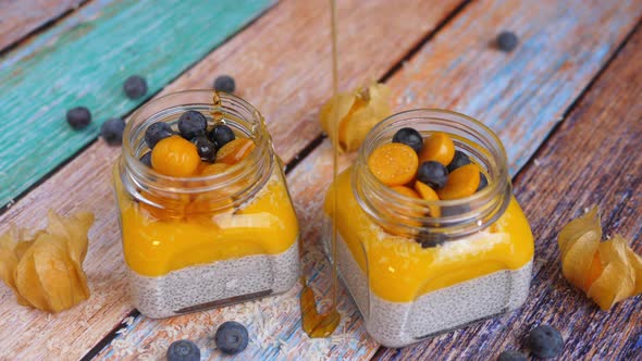 Healthy Vegan Breakfast: Chia Pudding With Fruits, Berries And Maple Syrup.  alt