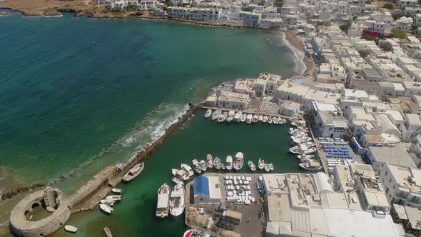 Aerial view of harbor at Naousa city, with traditional white houses, Greece. alt