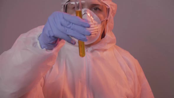 Protected Scientist Pouring Liquid in a Laboratory. Research and Science Concept alt