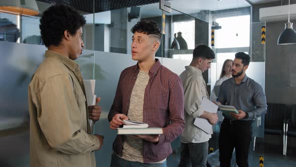 Diverse Young People Employees Communicate at Meeting in Business Center Students Stand Near alt