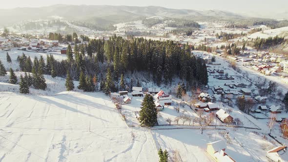 Village Covered with Snow in a Mountain Valley