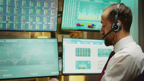 Close Up of Stock Market Broker Talking on Headphones alt