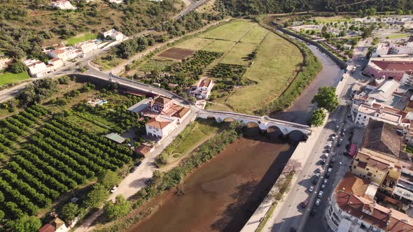 Rotating aerial of Ponte Velha, the monumental arched bridge in Silves, Portugal alt