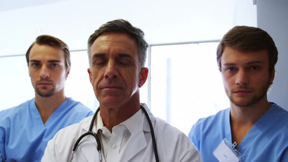 Portrait of medical team standing in operating room alt