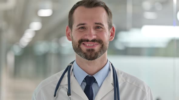 Portrait of Cheerful Male Doctor Smiling at the Camera alt