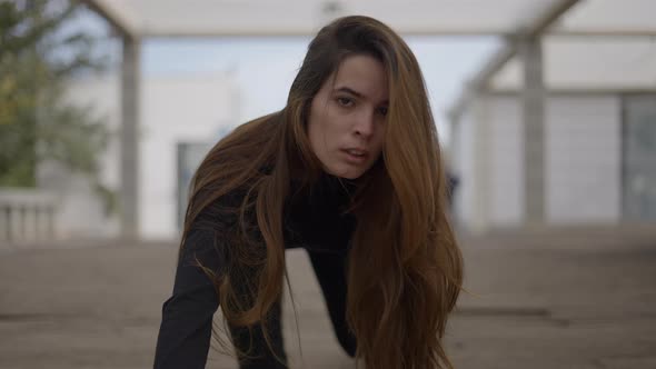 Young Woman with Crazy Expression Crawls Closer and Looks Into Camera alt