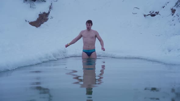 Young Man Swim in Winter River