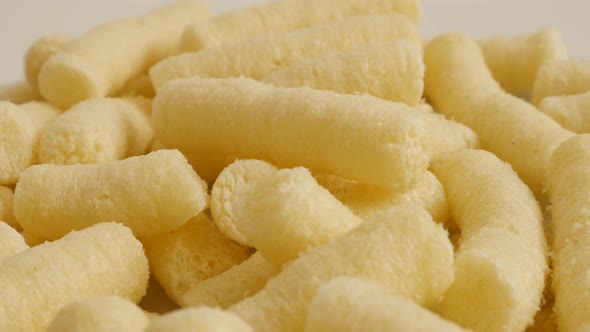 Close-up of  corn flips puffs  food  background slow pan 4K 2160p 30fps UltraHD footage - Unhealthy  alt