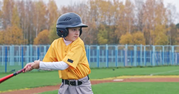 Portrait of a Boy Baseball Player on a Blurry Background the Batter in Protective Gear Waiting for a alt
