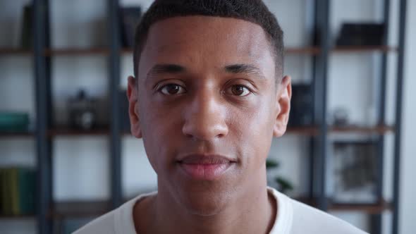 Confident Portrait of Young African American Guy Looking to the Camera at Home Office Background alt