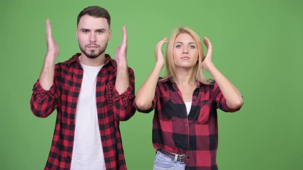 Young Couple Covering Ears Together As Three Wise Monkeys Concept