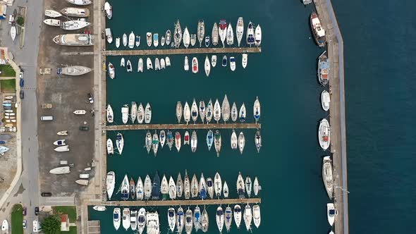 Aerial Footage of Yacht Club Located at Greece Island. Drone Flying Over White Sailing Boats and