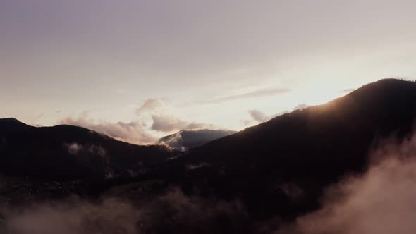 Panoramic View of a Picturesque Mountain Valley with a Village in a Lowland alt