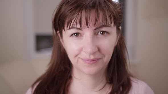 Portrait of a Woman at Home Looking at the Camera and Smiling Close Up Moving Camera