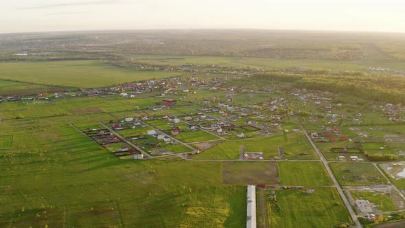 Drone flying above fields and village