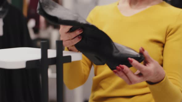 Closeup Caucasian Elegant Middleaged Woman Customer Shopper in Fashionable Boutique Clothing Store alt