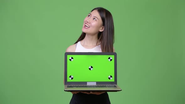 Young Beautiful Asian Businesswoman Showing Laptop