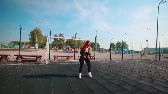 The girl on the playground performs a cool dance. The concept of teaching hip hop