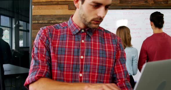Male executive using laptop in the conference room alt