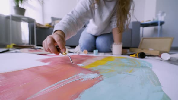 Woman Applying and Mixes Colors on Paper Sheet