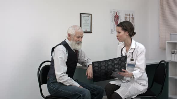 Patient Smiling While Doctor Telling Results of Mri alt