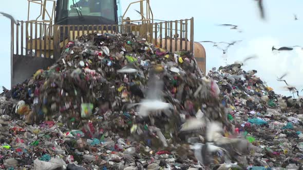 Truck moving waste on a landfill site